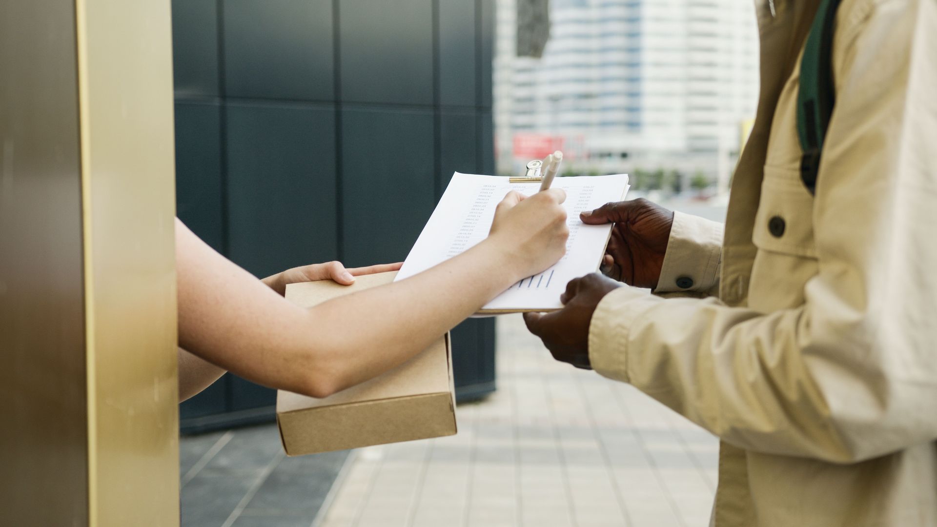 An outdoor scene of a package being delivered and a receipt being signed.